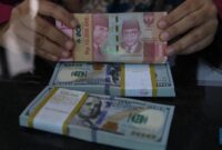 Layar menampilkan pergerakan nilai tukar rupiah yang melemah terhadap dolar AS pada perdagangan terbaru