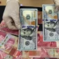 Nilai tukar rupiah menguat tipis terhadap dolar AS pada perdagangan Senin (24/8/2026).(Foto : Liputan6.com/Johan Tallo)