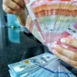 Rupiah melemah ke Rp18.080 per dolar AS pada penutupan perdagangan Jumat (23/10/2026).